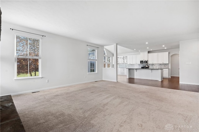 unfurnished living room featuring dark hardwood / wood-style floors