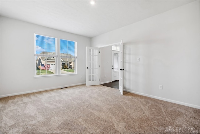 unfurnished bedroom with carpet and french doors