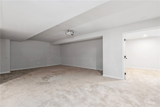 unfurnished room featuring light colored carpet