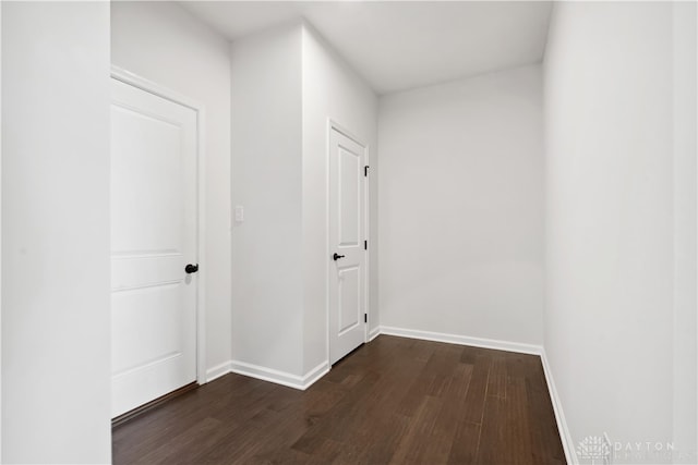 corridor with dark hardwood / wood-style floors