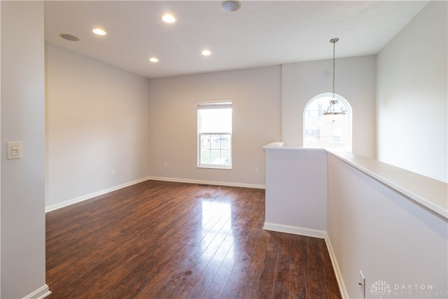 empty room with dark wood-type flooring