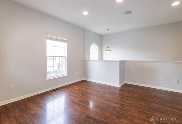 empty room with dark wood-type flooring