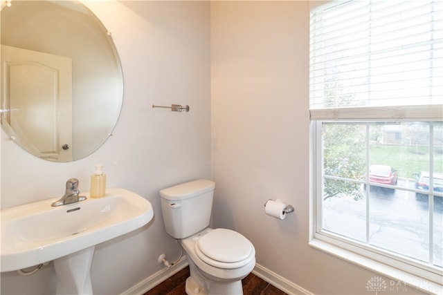 bathroom with hardwood / wood-style floors, toilet, and sink