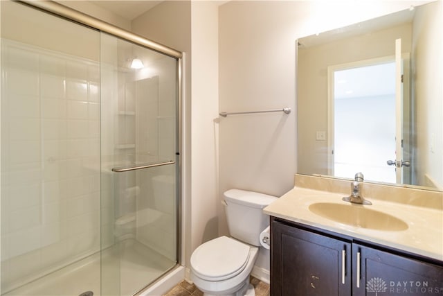 bathroom featuring walk in shower, vanity, and toilet