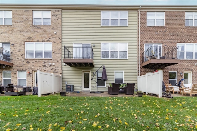 back of house with a lawn, central AC, and a patio area