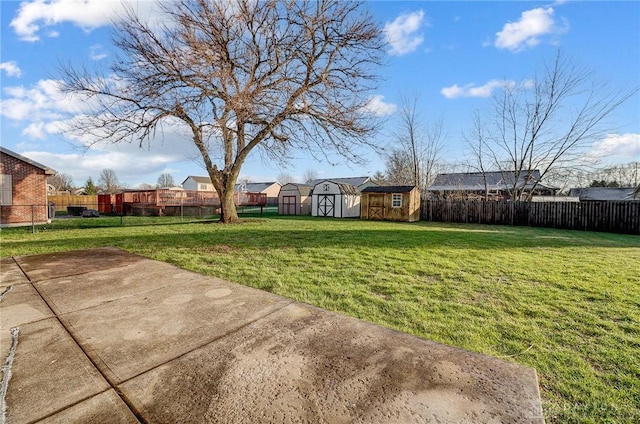 view of yard featuring a storage unit and a patio