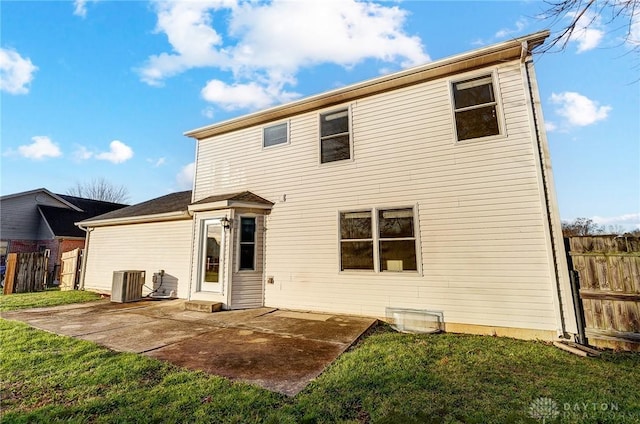 rear view of property featuring a patio, a yard, and central AC unit