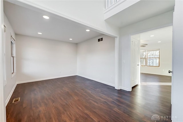 unfurnished room featuring dark wood-type flooring