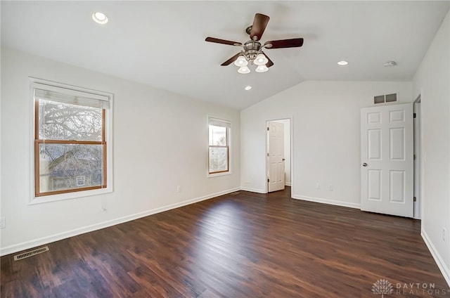 unfurnished bedroom featuring dark wood-type flooring, ceiling fan, and vaulted ceiling