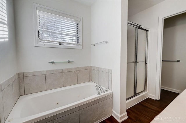 bathroom featuring hardwood / wood-style floors and independent shower and bath