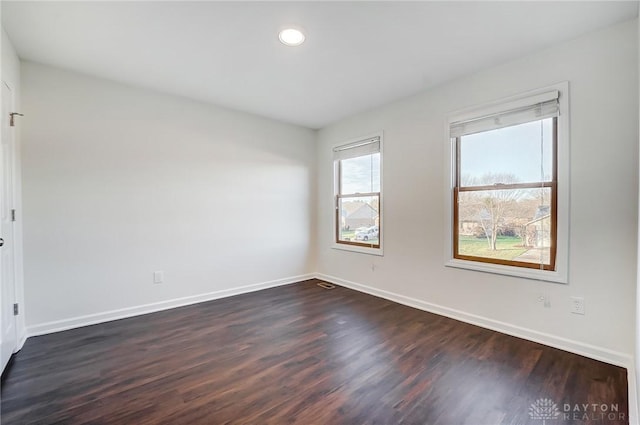 unfurnished room featuring dark wood-type flooring