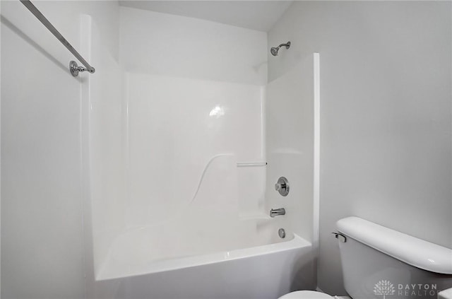 bathroom featuring shower / bathtub combination and toilet