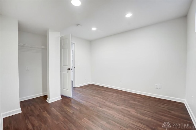 unfurnished bedroom featuring dark hardwood / wood-style floors and a closet