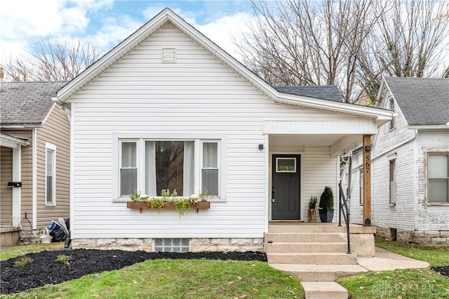 bungalow-style home with a porch and a front lawn