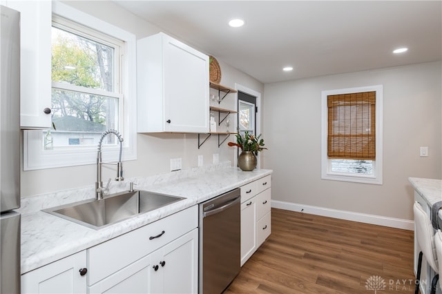 kitchen featuring white cabinets, sink, stainless steel dishwasher, dark hardwood / wood-style floors, and light stone countertops