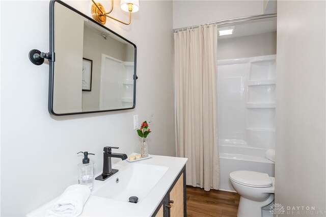 full bathroom with shower / tub combo, vanity, hardwood / wood-style flooring, and toilet