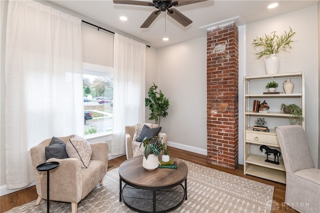 sitting room with hardwood / wood-style flooring and ceiling fan