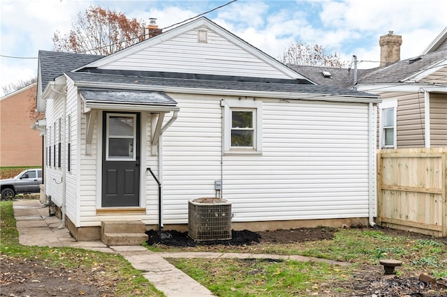 rear view of property featuring central AC unit