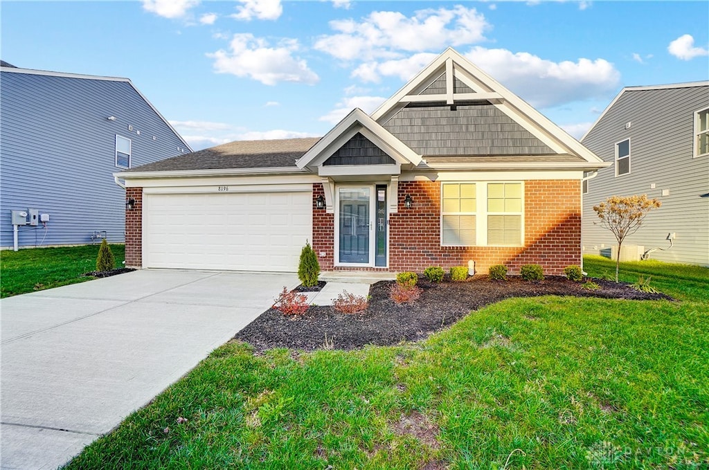 view of front of property with a front yard and a garage