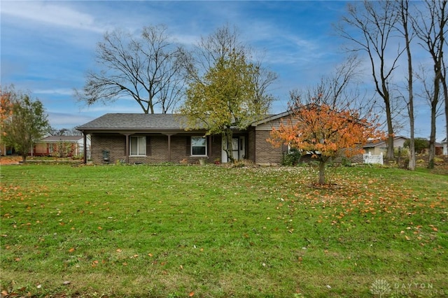 view of front of home with brick siding and a front yard