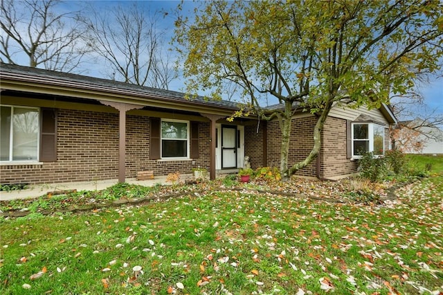 ranch-style home with brick siding and a front lawn