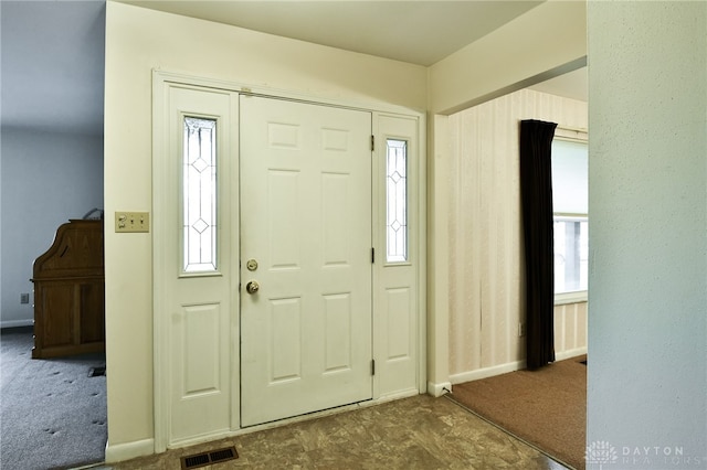 carpeted foyer entrance with plenty of natural light