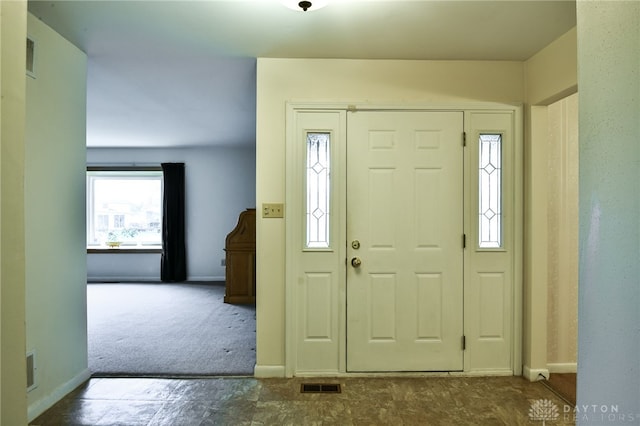 entrance foyer featuring carpet flooring