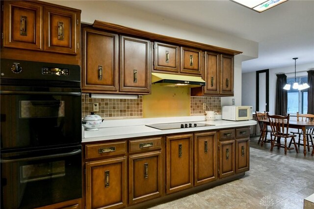 kitchen with tasteful backsplash, black appliances, decorative light fixtures, and a notable chandelier