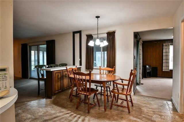 5331 Birchbend Ct, Dayton, OH 45415 - dining space with wooden walls, a wealth of natural light, and an inviting chandelier