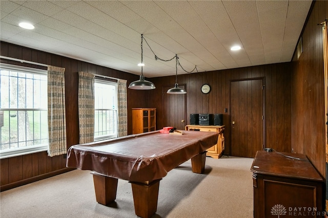 rec room with carpet, billiards, and wooden walls