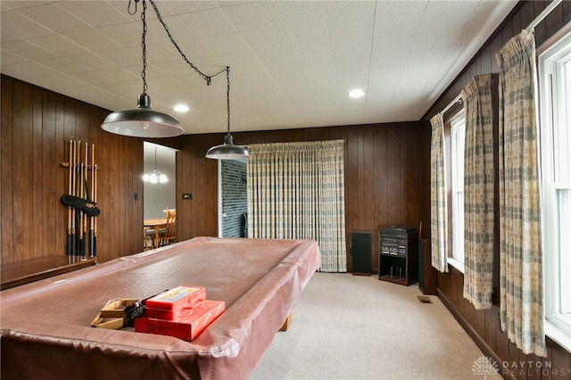 recreation room featuring light carpet, wooden walls, and billiards