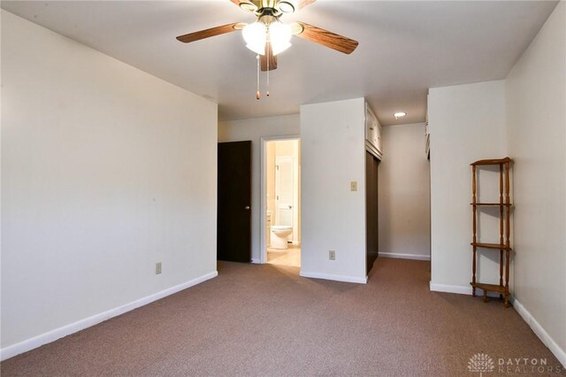 unfurnished bedroom with light carpet, connected bathroom, and ceiling fan