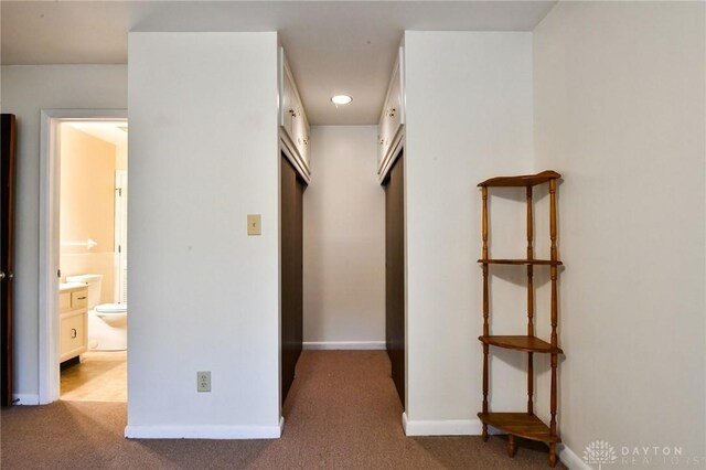 hall with light colored carpet