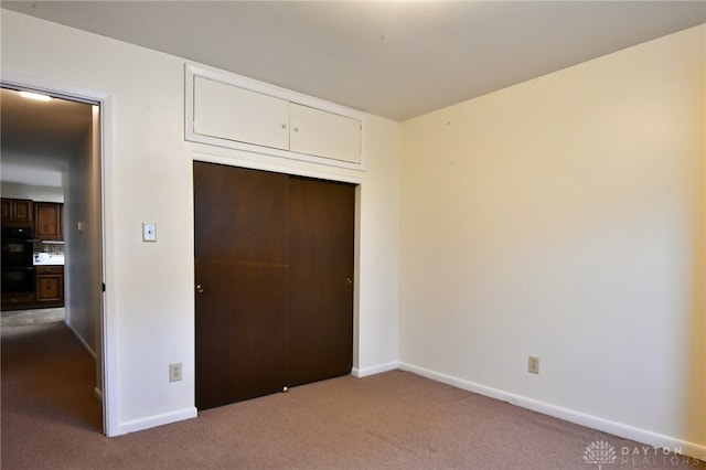 unfurnished bedroom with carpet floors and a closet