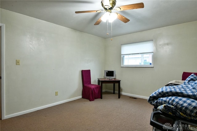 living area with light colored carpet and ceiling fan