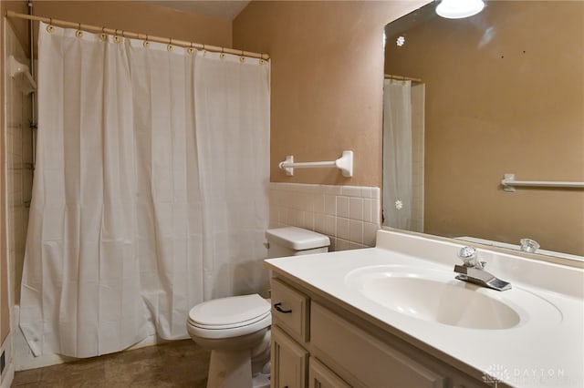 bathroom with vanity, toilet, curtained shower, and tile walls