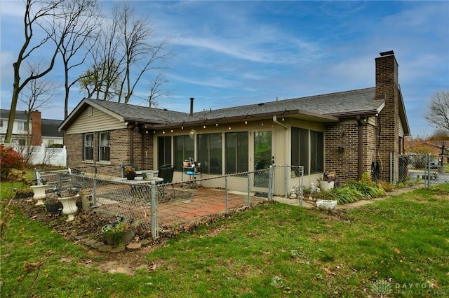 5331 Birchbend Ct, Dayton, OH 45415 - rear view of house with a yard, brick siding, a chimney, and a sunroom