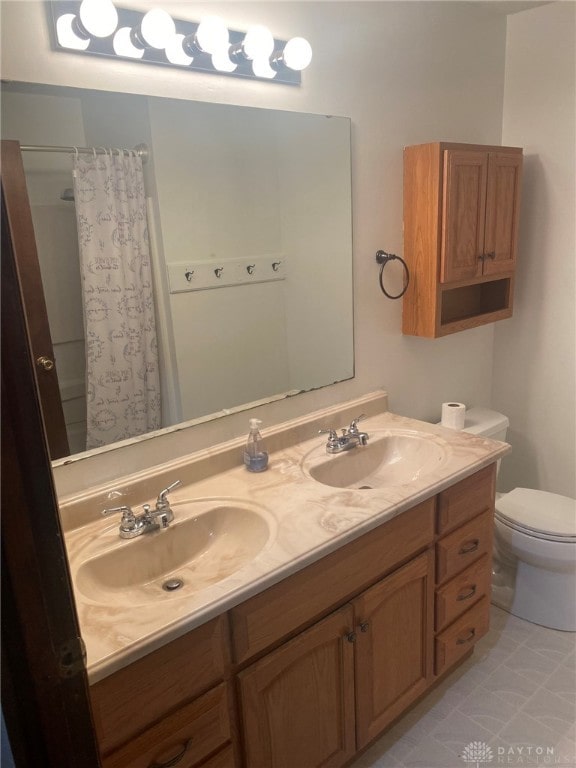 bathroom featuring walk in shower, vanity, and toilet