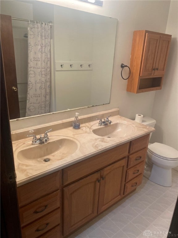 bathroom featuring a shower with shower curtain, vanity, and toilet