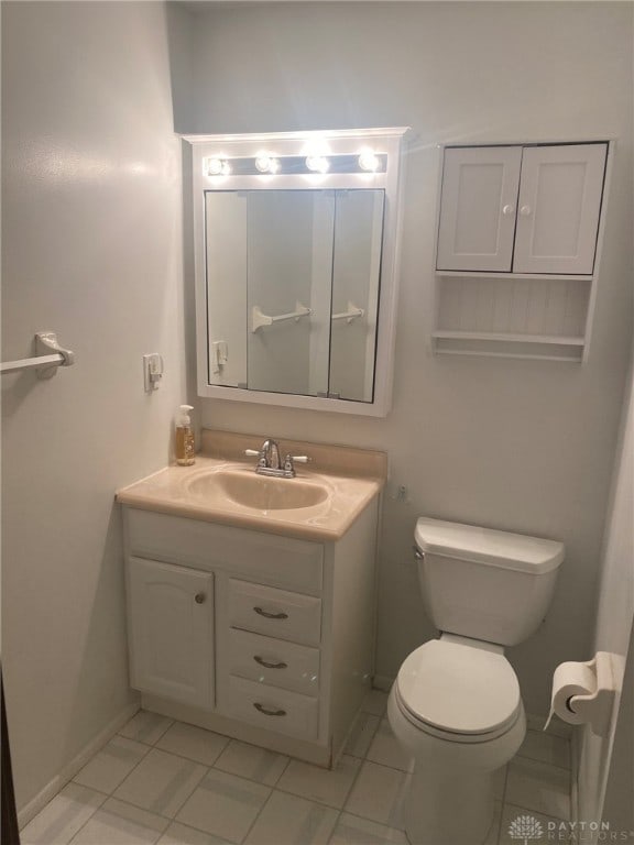 bathroom with tile patterned floors, vanity, and toilet