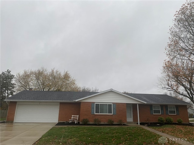 single story home featuring a garage and a front lawn