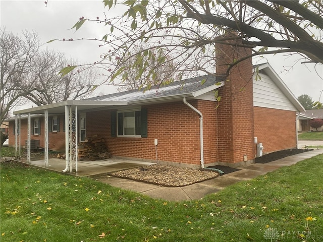 rear view of house with a yard and a patio