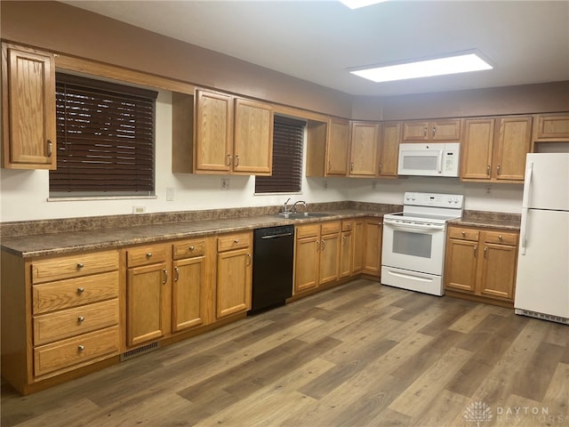 kitchen with white appliances, dark wood-type flooring, and sink