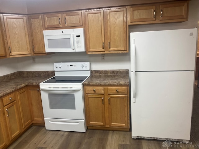 kitchen featuring white appliances and dark wood-type flooring