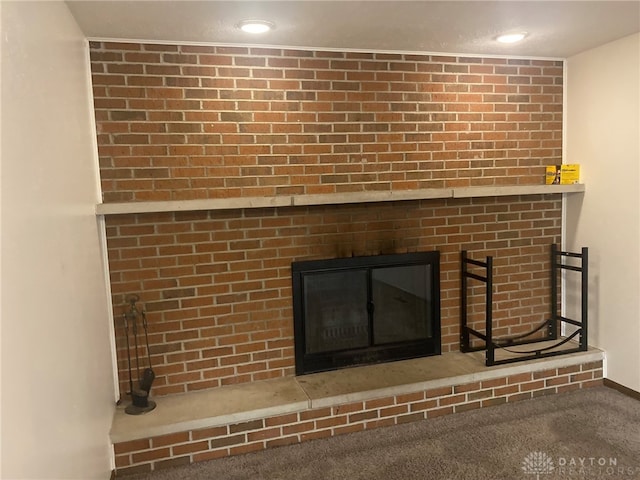 room details featuring a fireplace and carpet floors