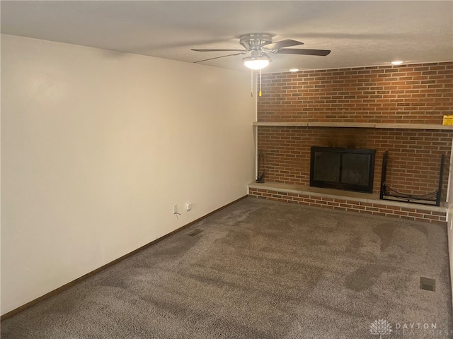 unfurnished living room featuring carpet flooring, a fireplace, and ceiling fan