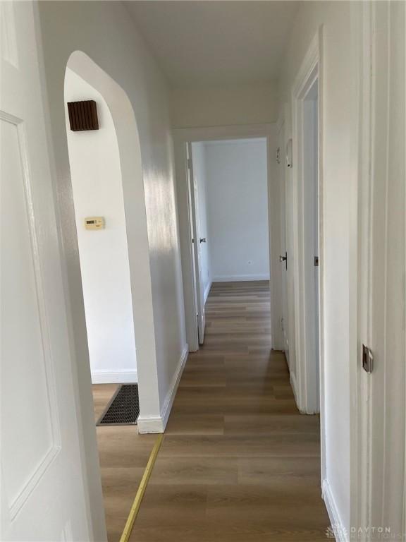 hallway with wood-type flooring