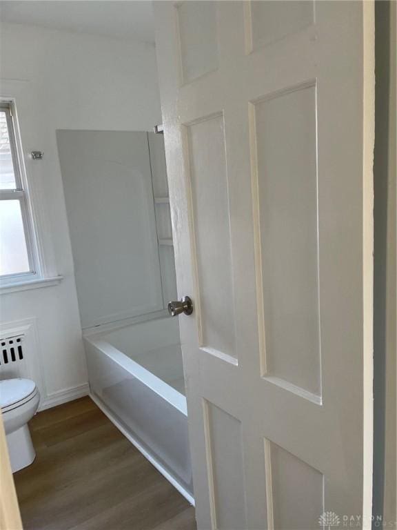 bathroom featuring hardwood / wood-style floors and toilet