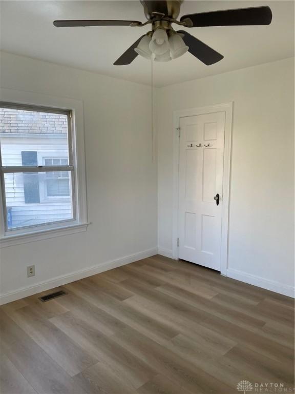 unfurnished room featuring wood-type flooring and ceiling fan