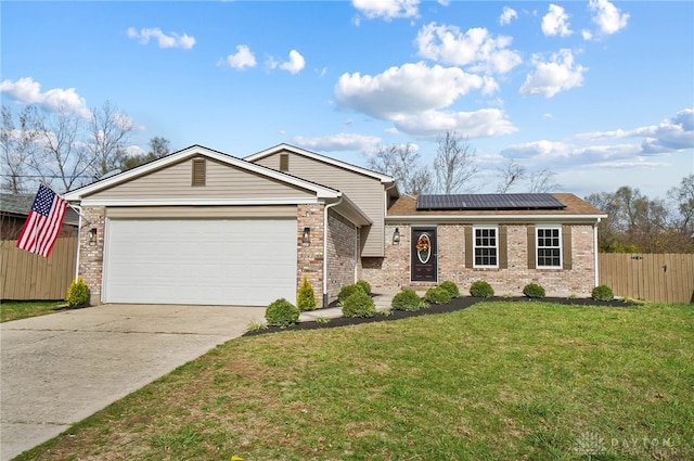 view of front of property with solar panels, a garage, and a front lawn